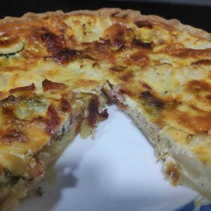 quiche de verduras con una porción cortada