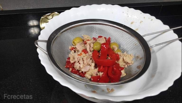 atún, olivas y pimiento en un escurridor