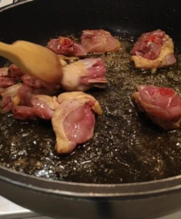 fregint carn a la paellera
