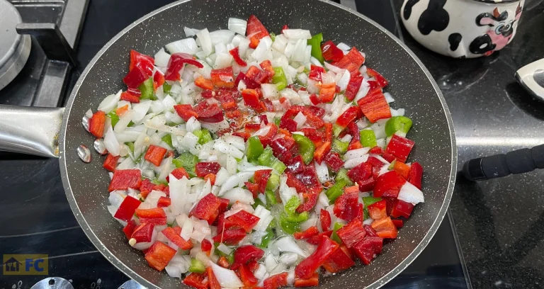 en una paella sofregit de ceba, pebrot verd i vermell