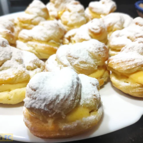 Un plato blanco con muchas lionesas de crema