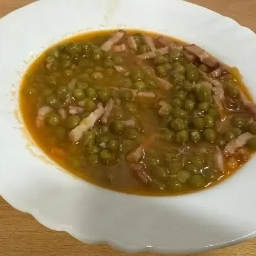 un plat amb pèsols stofats amb bacó