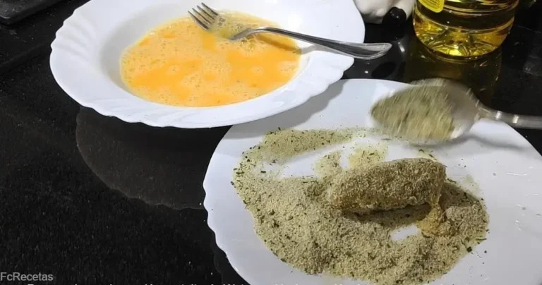 formando y rebozando las croquetas caseras de jamón con huevo batido y pan rallado